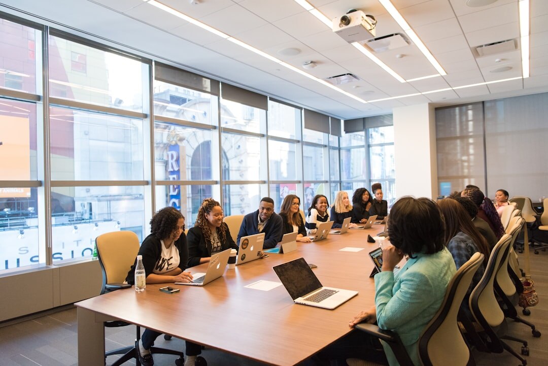 Team of editors reviewing documents and photos around a table