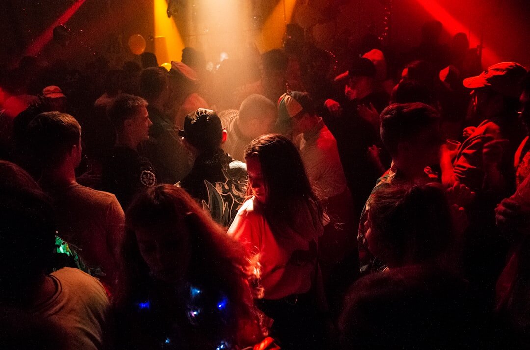 Glamorous nightlife party scene with colorful stage lighting and a crowd