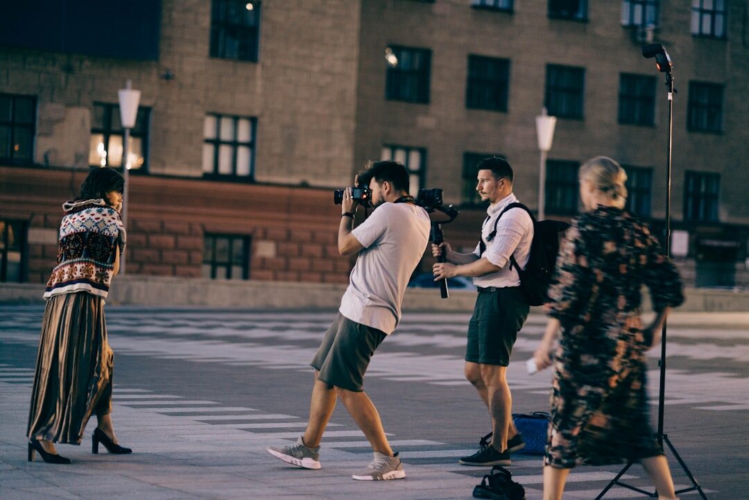 Photographers and flashing cameras at a red carpet celebrity event at night